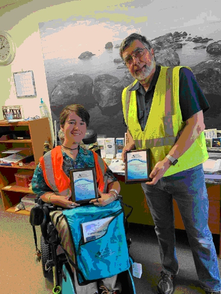 Shea (left, in wheelchair) & Tom displaying their national recognition awards